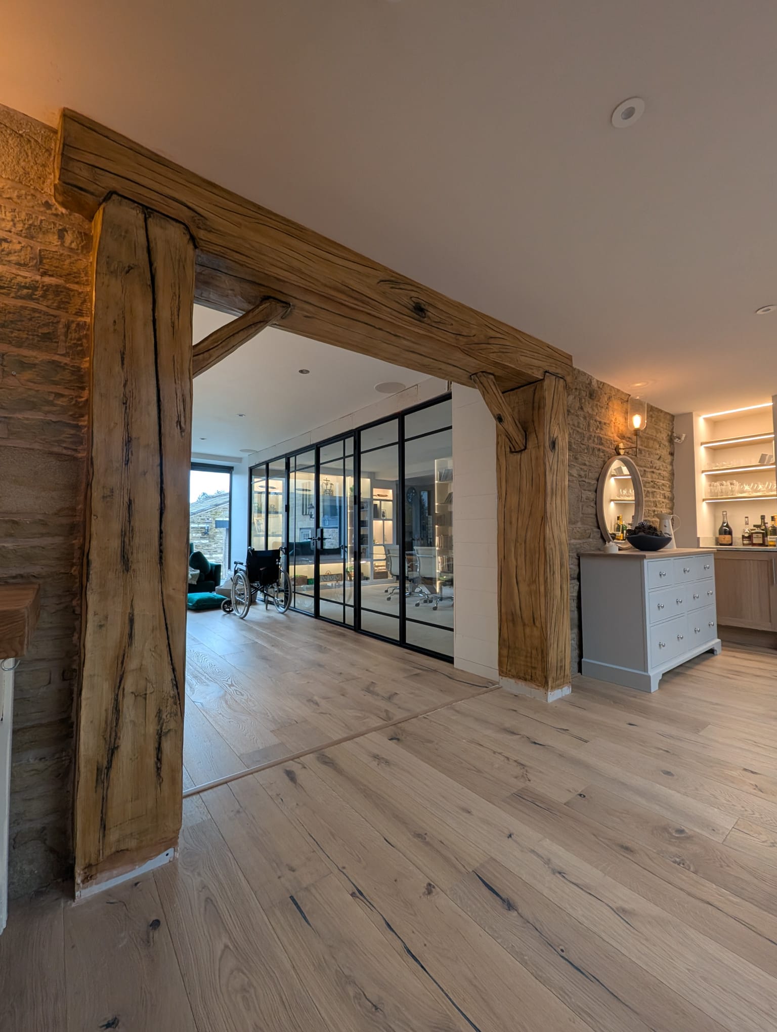 Hand-finished imitation oak beam framing an opening in a completed interior